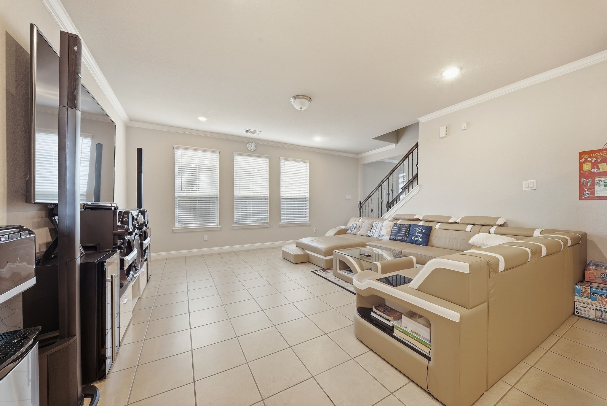 17714 Sugar Magnolia Lane Spring, TX 77379 - Photo 3 of 24 Bright, open living room with tall ceilings and a staircase, perfect for everyday living and entertaining.