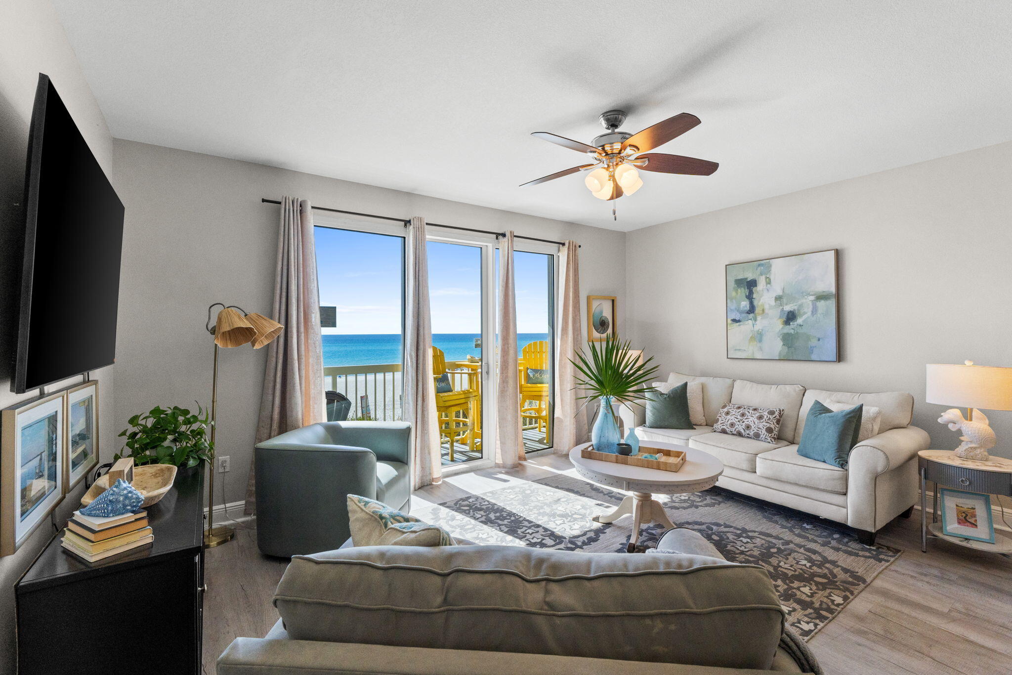 17757 Front Beach Road, Unit 104 Panama City Beach, FL 32413 - Photo 11 of 40 a living room with furniture a flat screen tv and a large window
