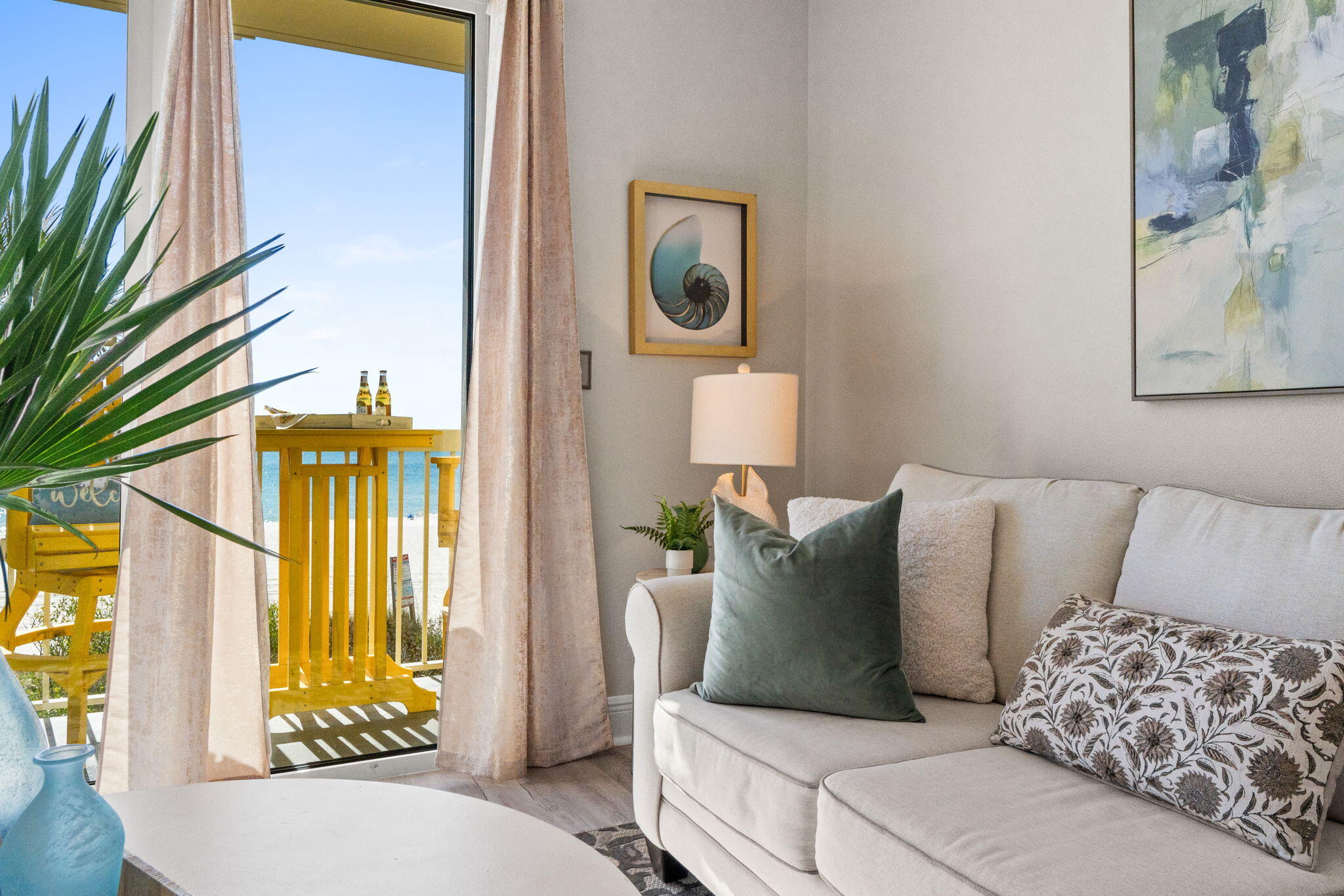 17757 Front Beach Road, Unit 104 Panama City Beach, FL 32413 - Photo 18 of 40 a living room with a couch and a chandelier