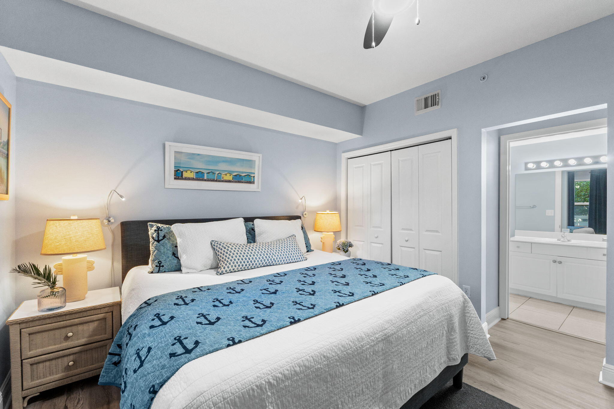 17757 Front Beach Road, Unit 104 Panama City Beach, FL 32413 - Photo 21 of 40 a bedroom with a large bed and a chandelier