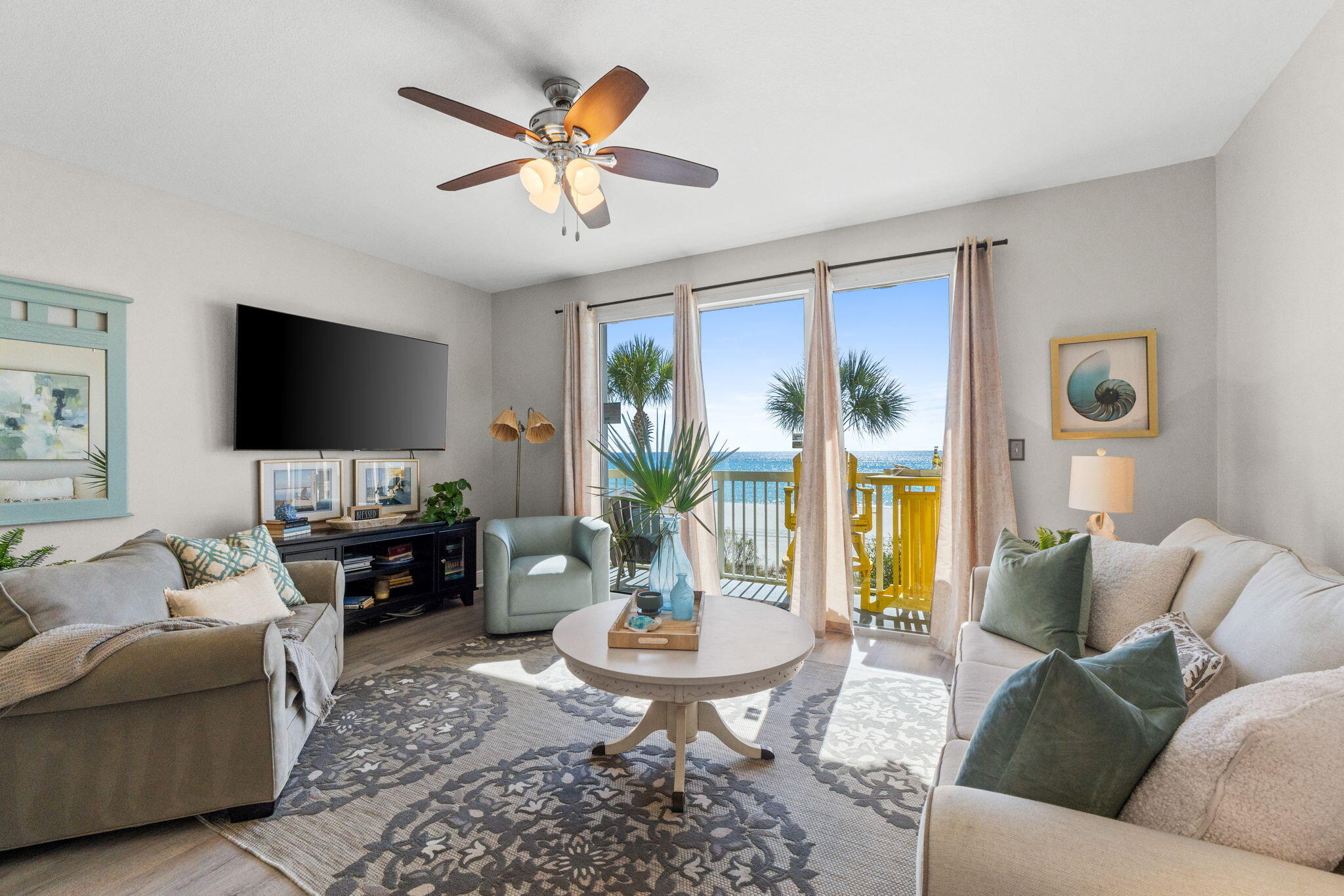 17757 Front Beach Road, Unit 104 Panama City Beach, FL 32413 - Photo 10 of 40 a living room with furniture and a flat screen tv