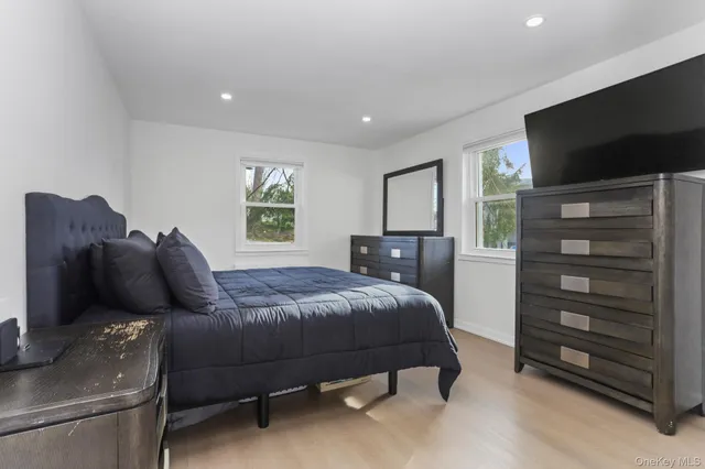 a bedroom with a bed and a television