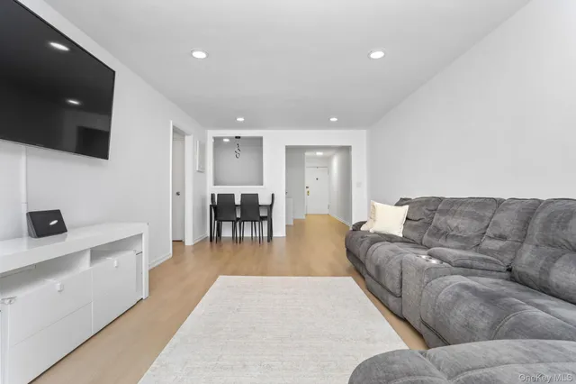 a living room with furniture a dining table and a flat screen tv