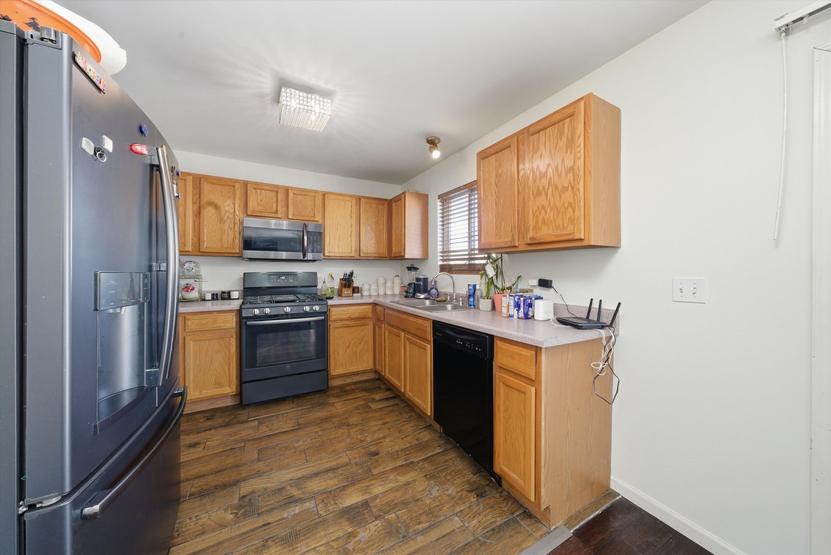 370 Dartmoor Avenue Romeoville, IL 60446 - Photo 11 of 31 a kitchen with stainless steel appliances granite countertop a stove refrigerator sink and a microwave