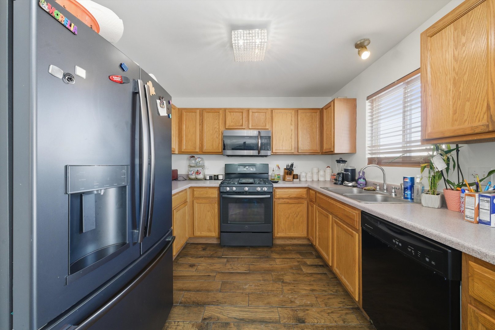 370 Dartmoor Avenue Romeoville, IL 60446 - Photo 14 of 31 a kitchen with stainless steel appliances a stove sink and cabinets