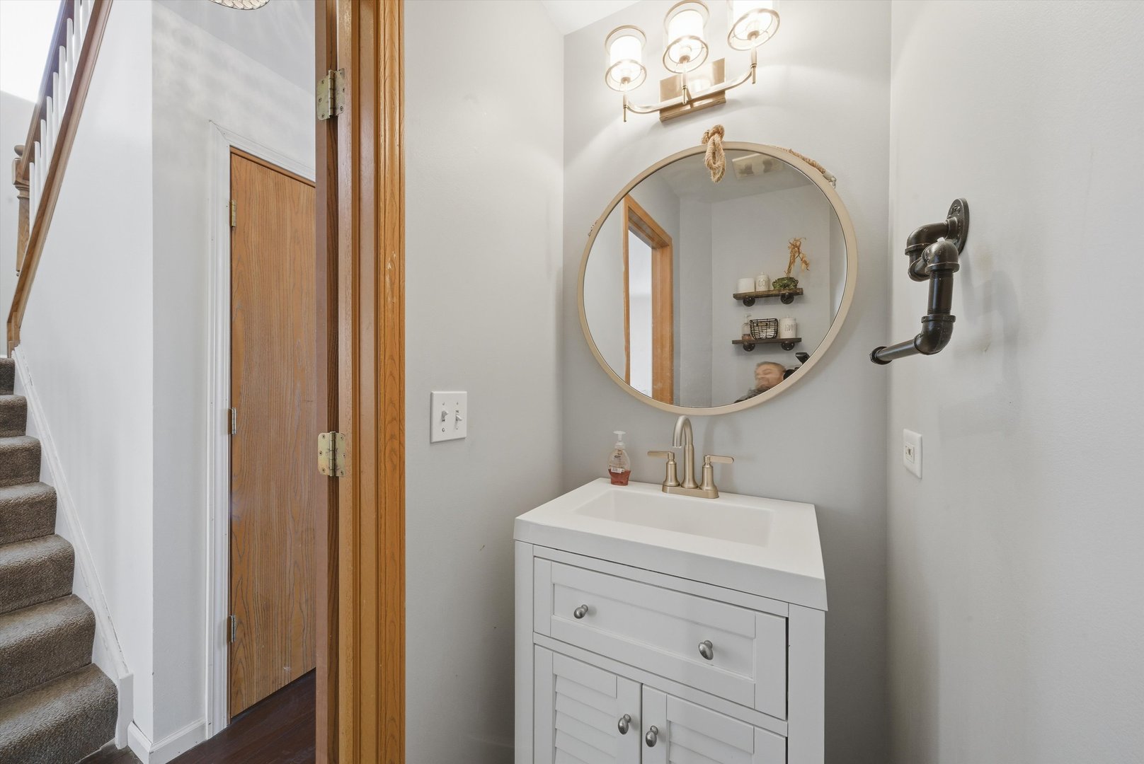 370 Dartmoor Avenue Romeoville, IL 60446 - Photo 10 of 31 a bathroom with a sink and a mirror
