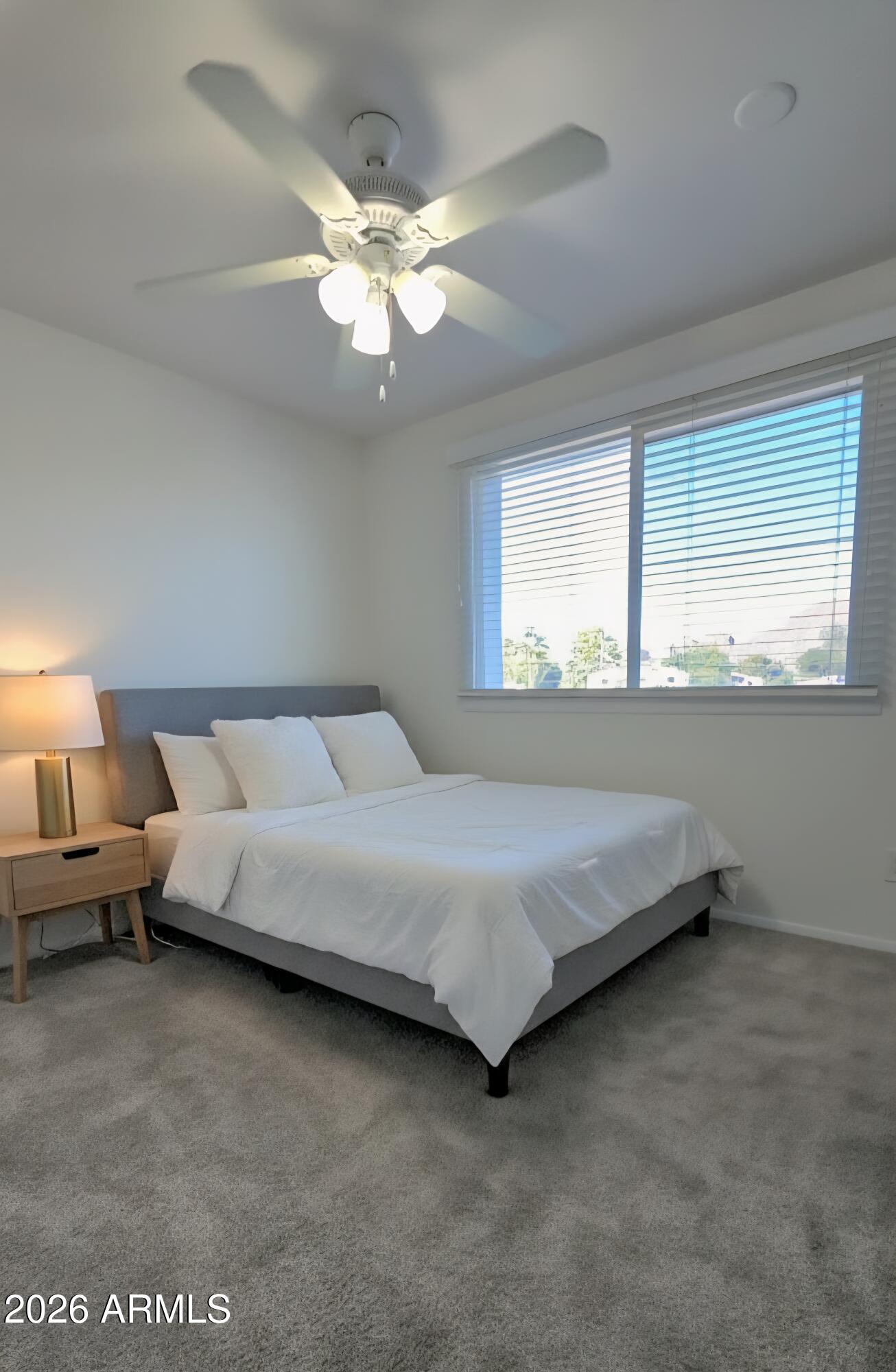 5853 East Thomas Road Scottsdale, AZ 85251 - Photo 11 of 18 a bedroom with bed and window