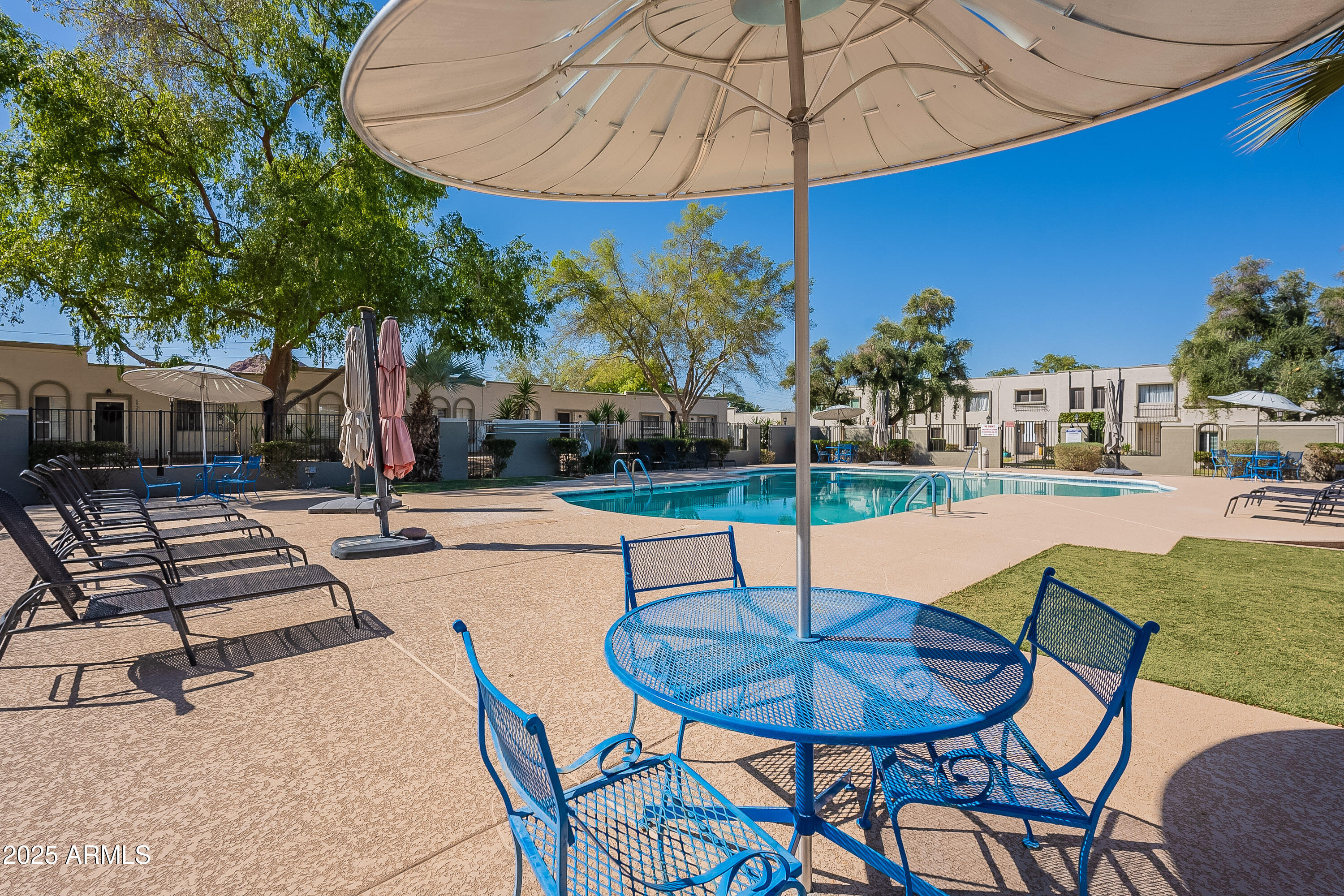 5853 East Thomas Road Scottsdale, AZ 85251 - Photo 16 of 18 a swimming pool with outdoor seating