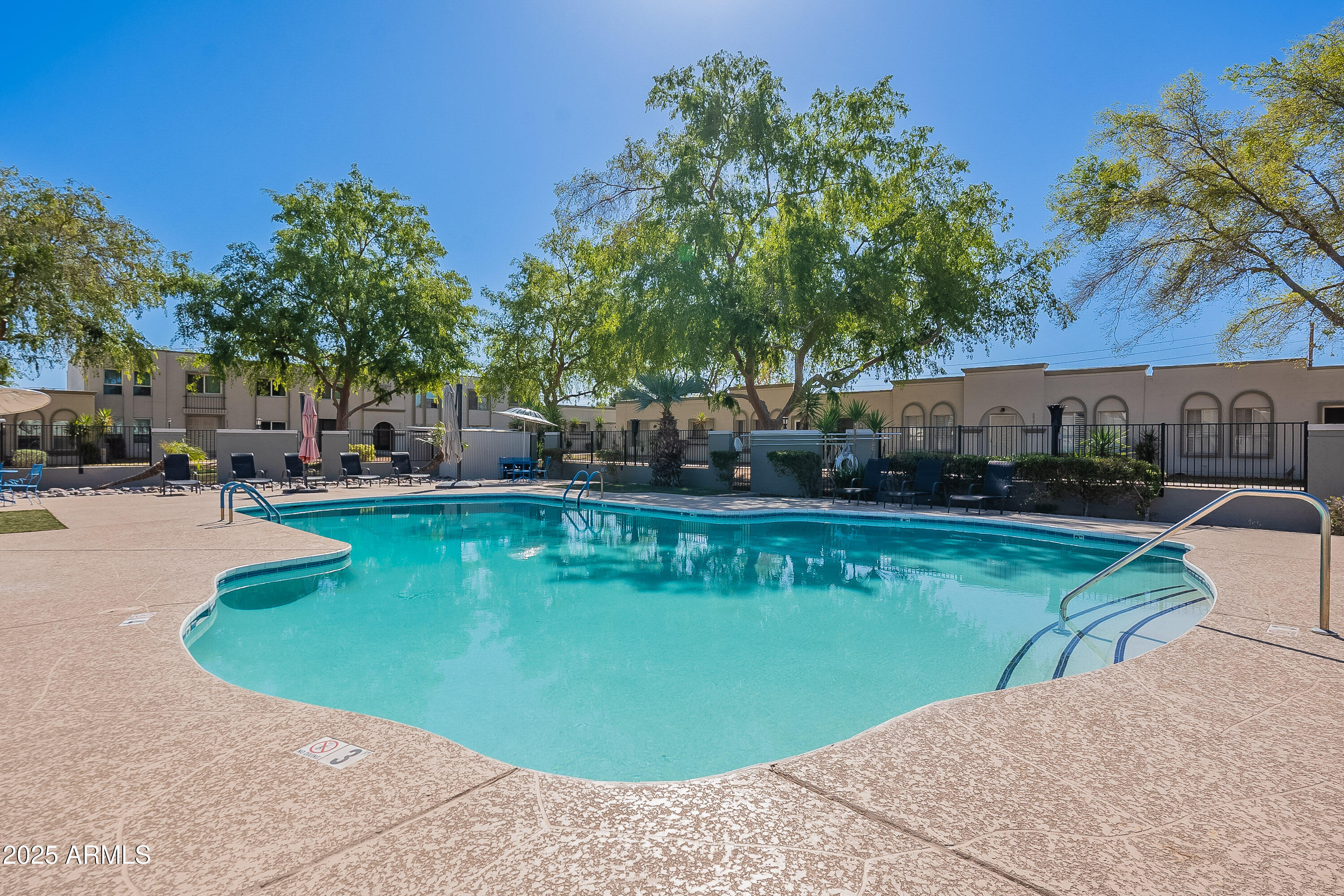 5853 East Thomas Road Scottsdale, AZ 85251 - Photo 17 of 18 a view of a swimming pool with chairs
