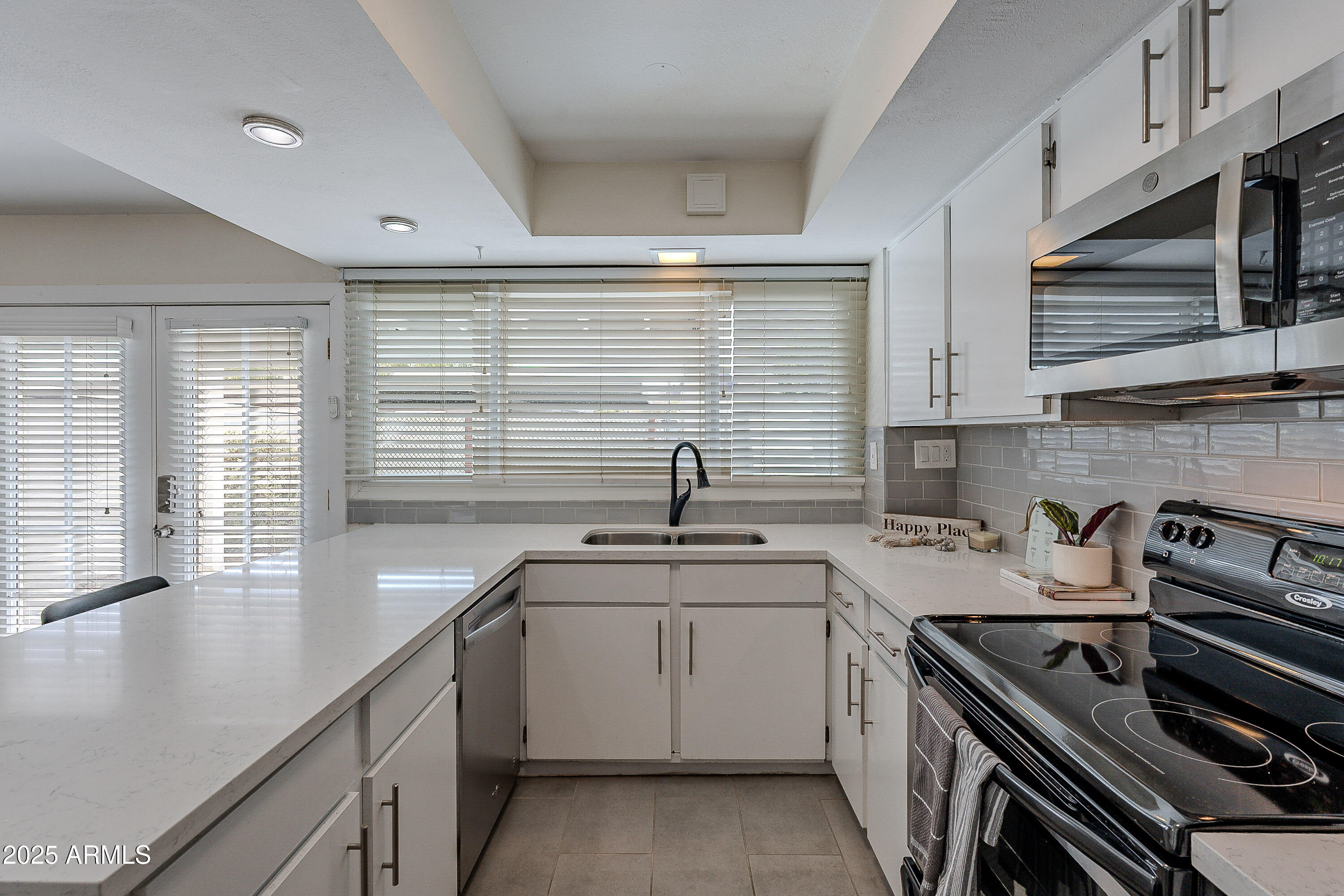 5853 East Thomas Road Scottsdale, AZ 85251 - Photo 4 of 18 a kitchen with a sink stove and cabinets