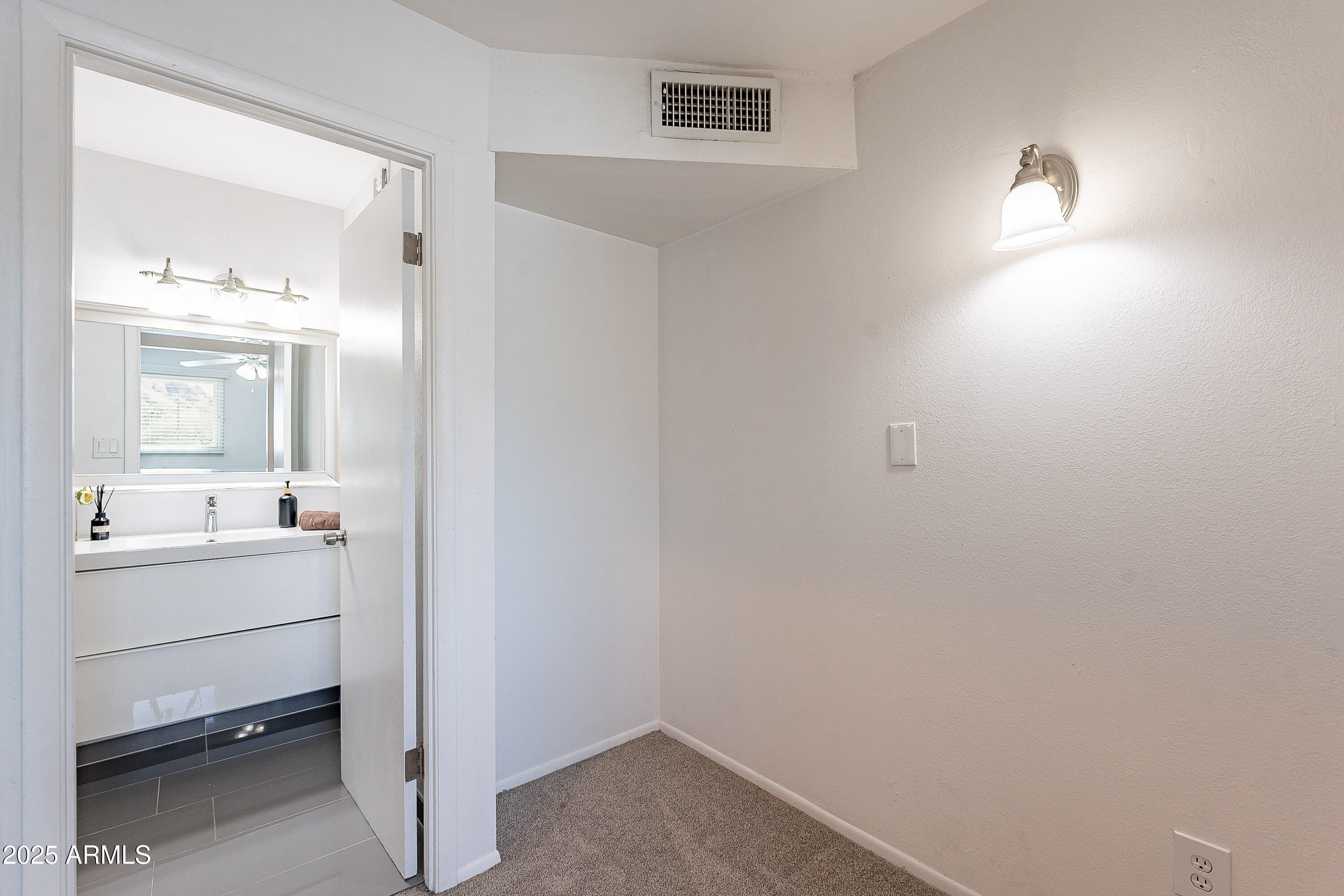 5853 East Thomas Road Scottsdale, AZ 85251 - Photo 8 of 18 a bathroom with a sink a light fixture and a mirror