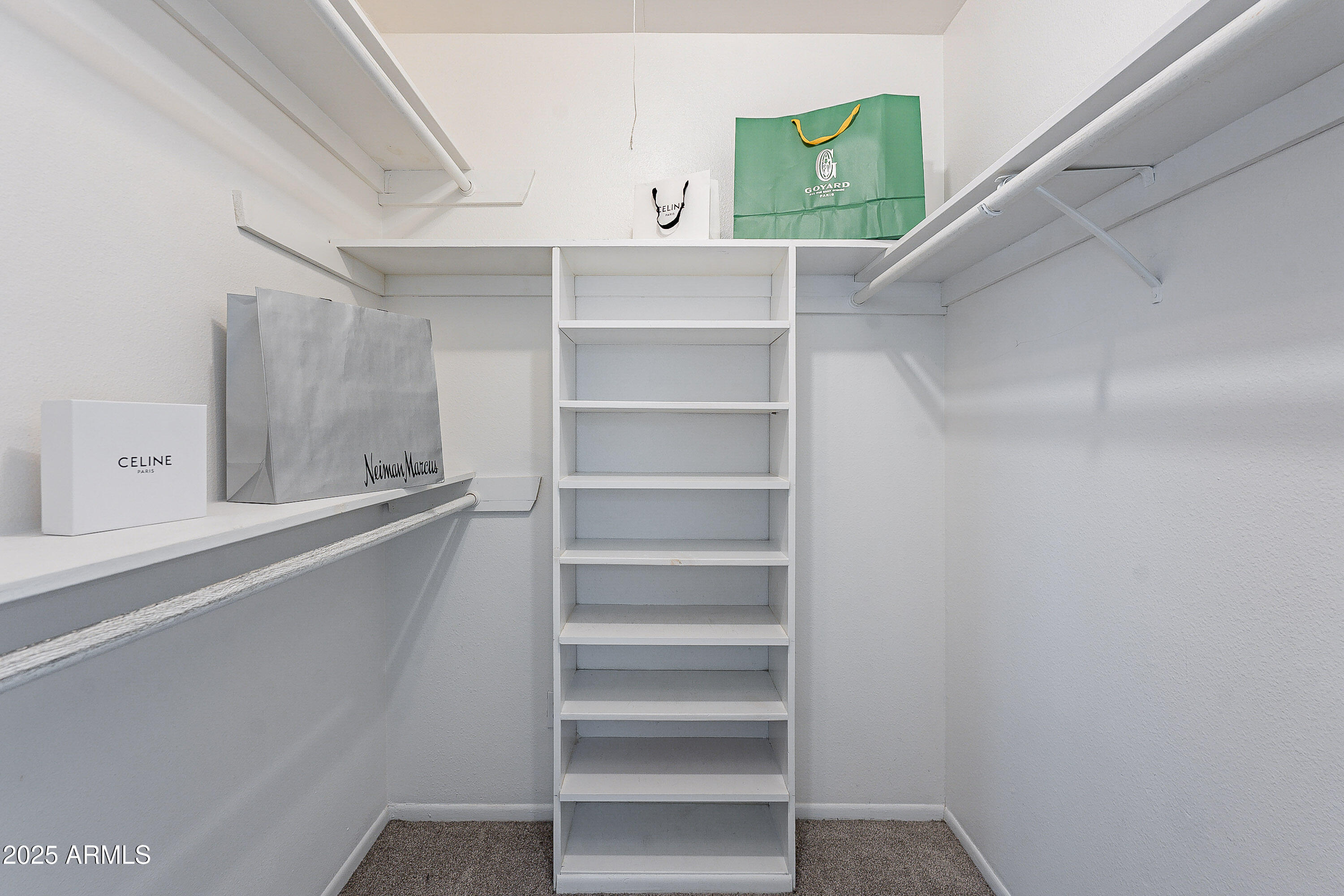 5853 East Thomas Road Scottsdale, AZ 85251 - Photo 10 of 18 a view of walk in closet with empty racks