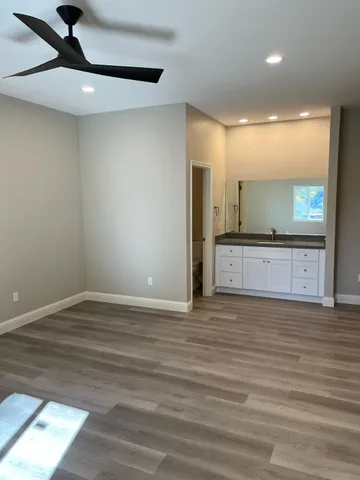 a view of a kitchen with a sink and a wooden floor