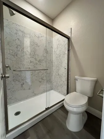 a bathroom with a toilet and a shower