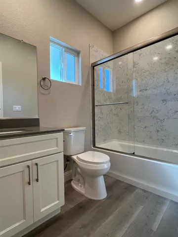 a bathroom with a toilet a sink and a shower