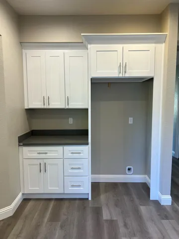 a view of cabinets and wooden floor