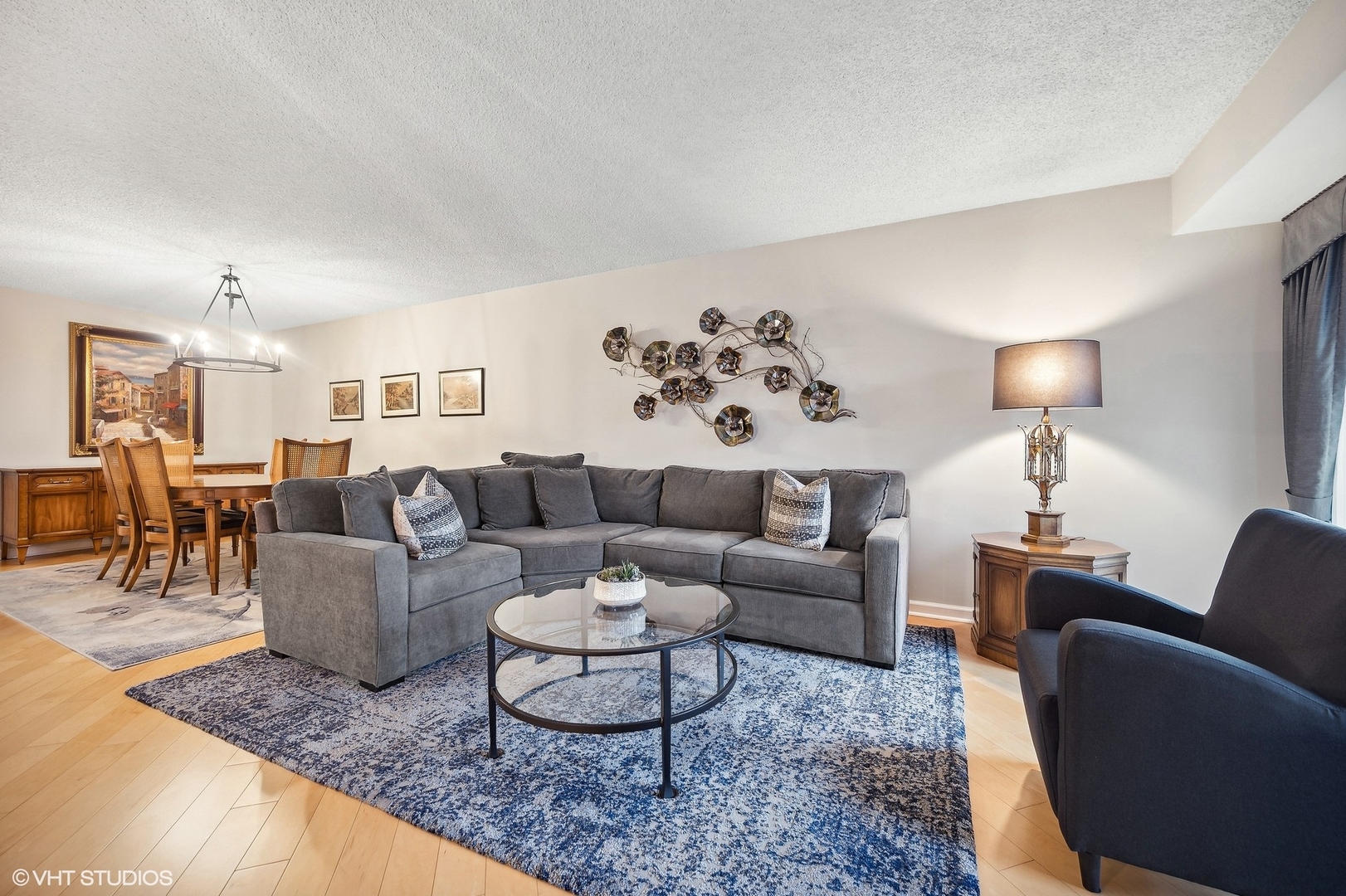 710 Waukegan Road, Unit 303 Glenview, IL 60025 - Photo 2 of 15 a living room with furniture potted plant and a lamp