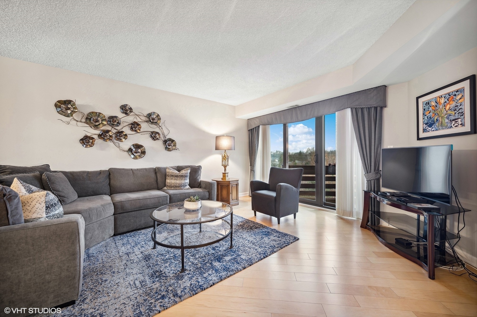 710 Waukegan Road, Unit 303 Glenview, IL 60025 - Photo 3 of 15 a living room with furniture and a flat screen tv
