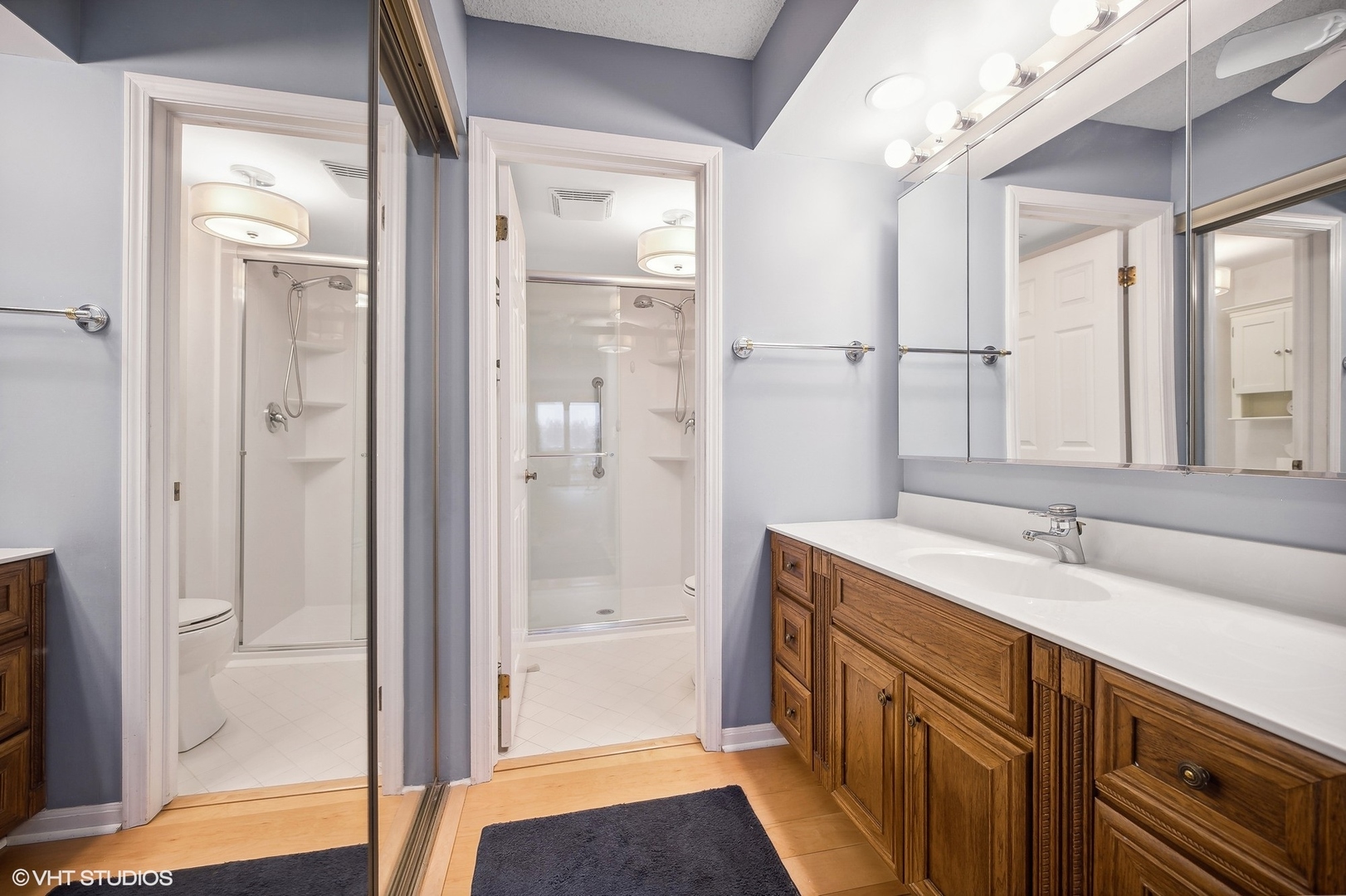 710 Waukegan Road, Unit 303 Glenview, IL 60025 - Photo 10 of 15 a bathroom with a sink a mirror and a shower