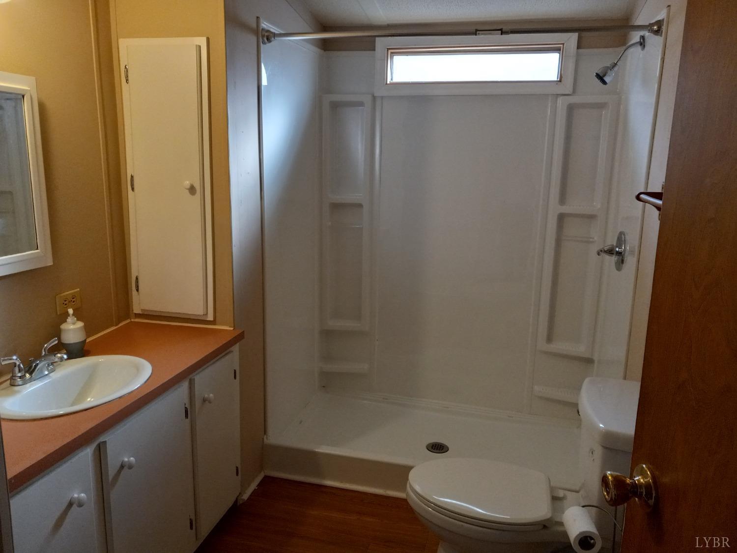 468 Hawkins Road Evington, VA 24550 - Photo 20 of 31 a bathroom with a granite countertop sink toilet and shower