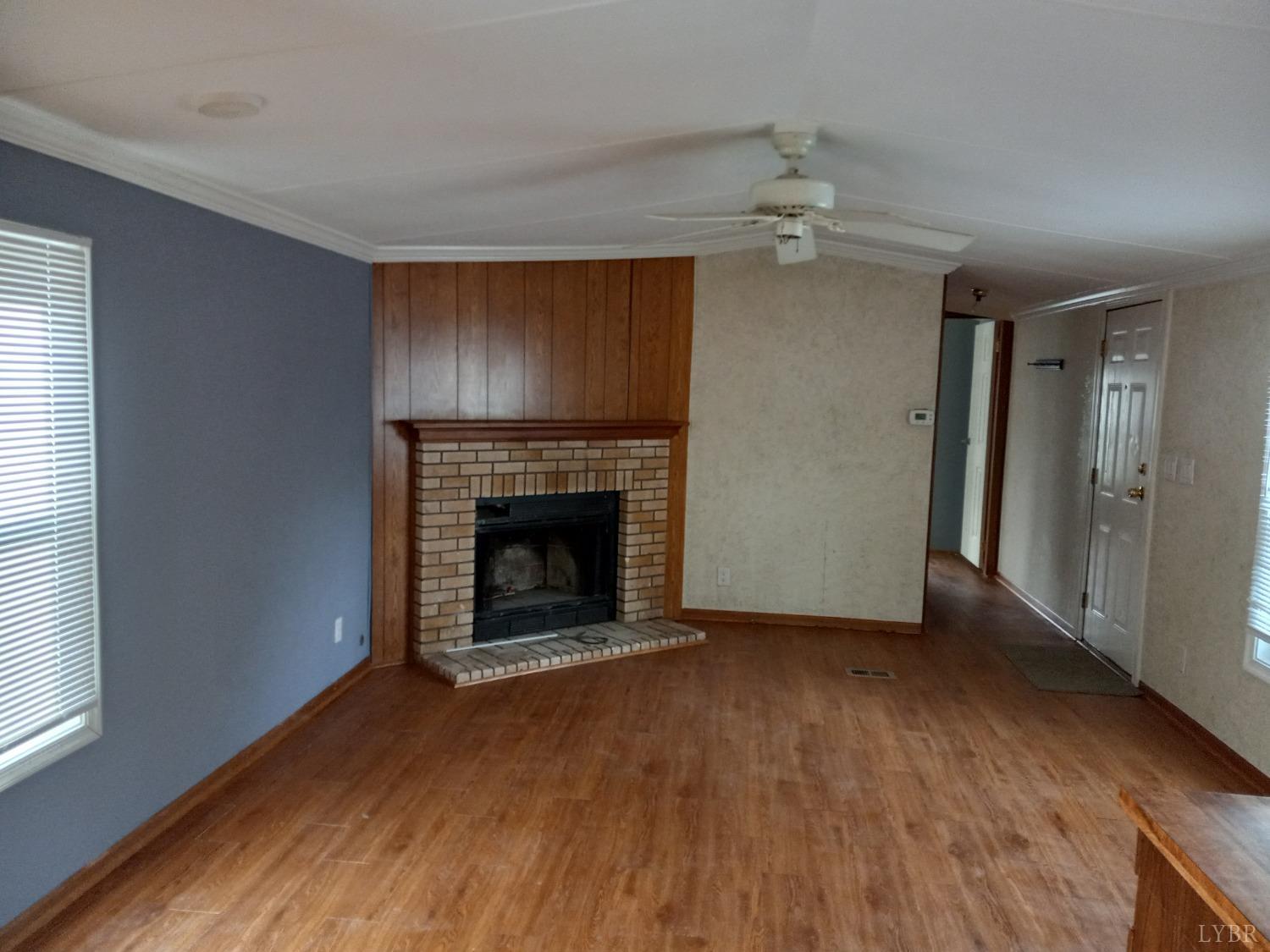 468 Hawkins Road Evington, VA 24550 - Photo 4 of 31 wooden floor fireplace and natural light in room