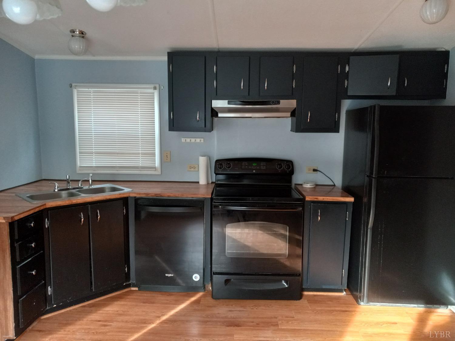 468 Hawkins Road Evington, VA 24550 - Photo 7 of 31 a kitchen with a cabinets and a stove top oven
