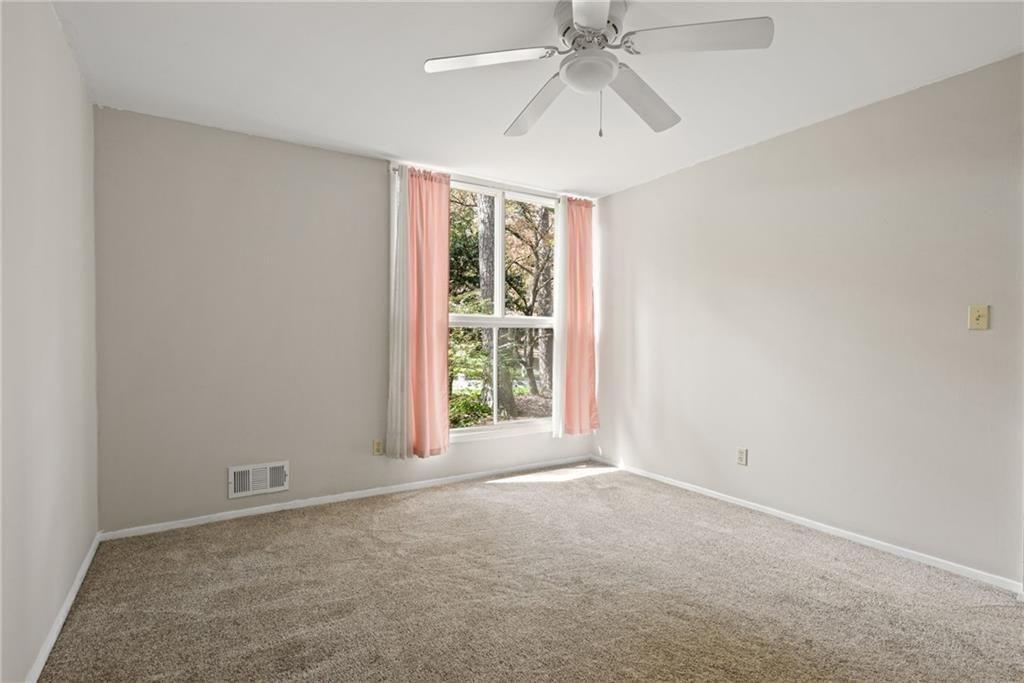 705 Edgewater Trail Sandy Springs, GA 30328 - Photo 27 of 36 an empty room with a window and a fan