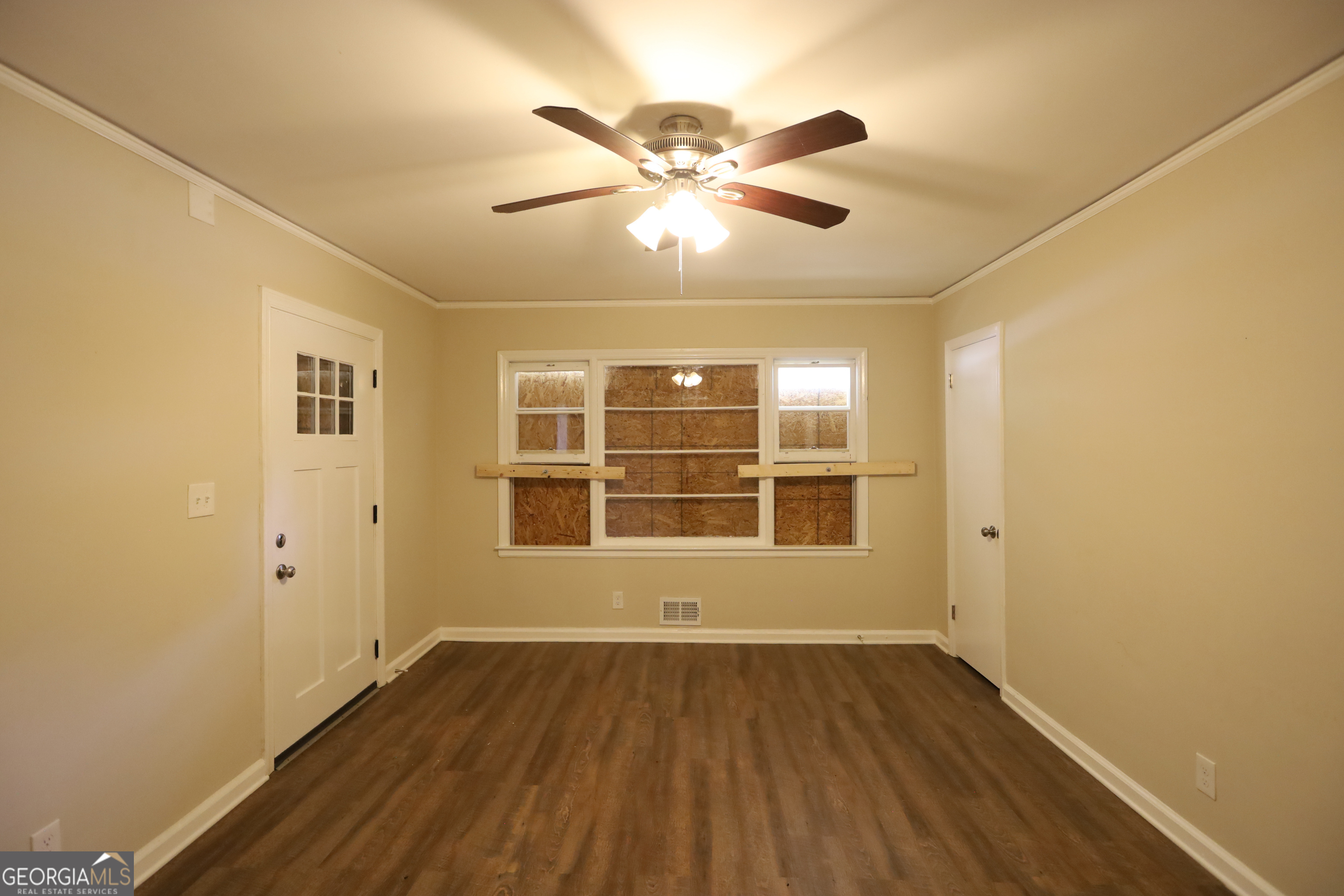 2364 Farley Street East Point, GA 30344 - Photo 5 of 10 a view of an empty room with wooden floor and a window