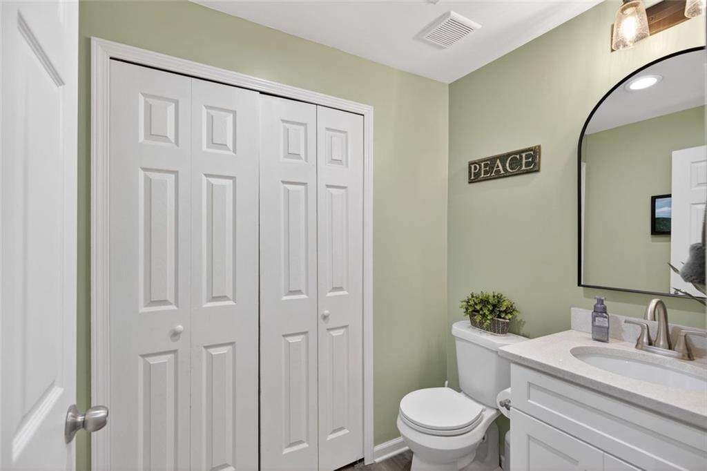 7280 Valley Drive Winston, GA 30187 - Photo 16 of 35 a bathroom with a granite countertop sink toilet a mirror and shower