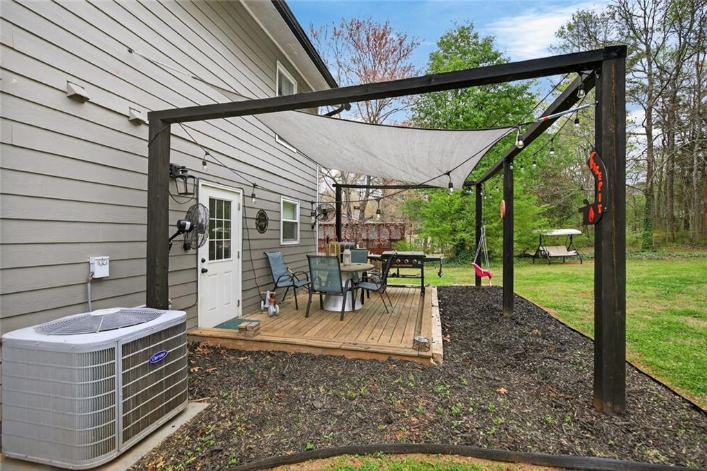 7280 Valley Drive Winston, GA 30187 - Photo 27 of 35 a view of a patio with a table chairs and backyard