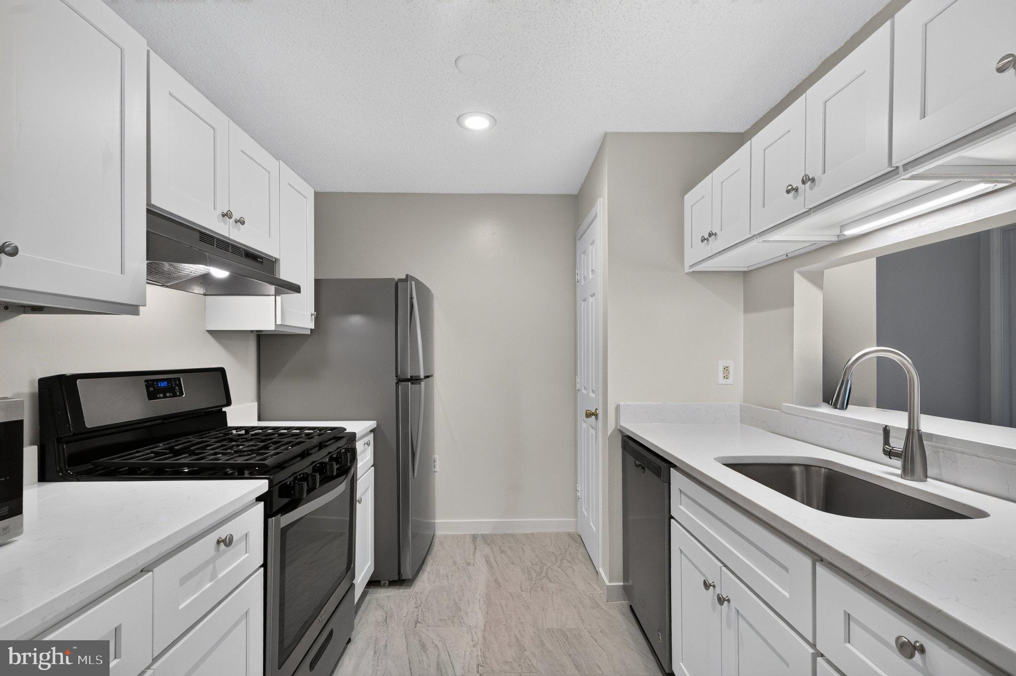 21029 Timber Ridge Terrace, Unit 302 Ashburn, VA 20147 - Photo 13 of 29 Modern kitchen with sleek finishes.