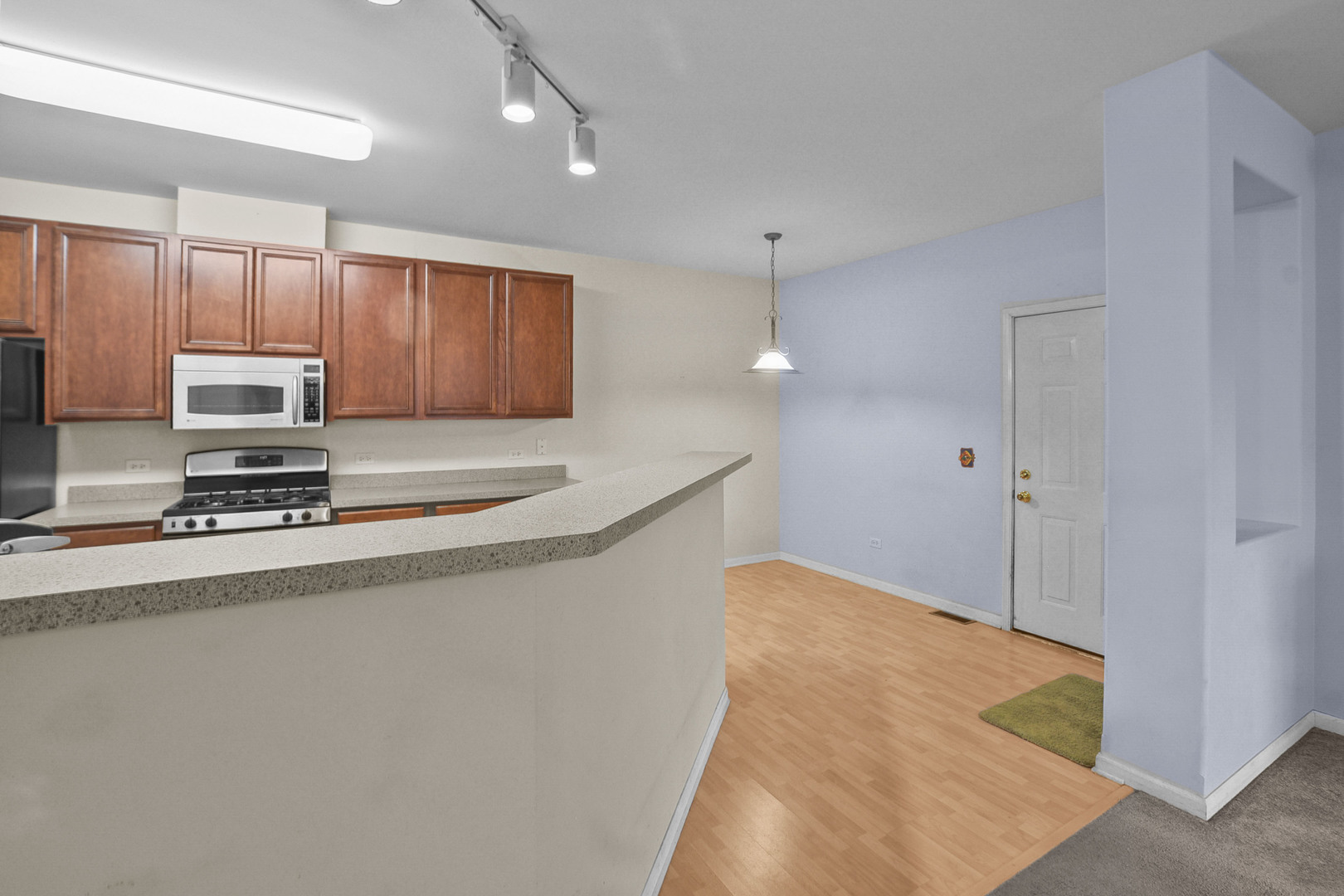 8815 Concord Lane, Unit G Justice, IL 60458 - Photo 12 of 27 a kitchen with stainless steel appliances a refrigerator a stove a sink cabinets and a refrigerator