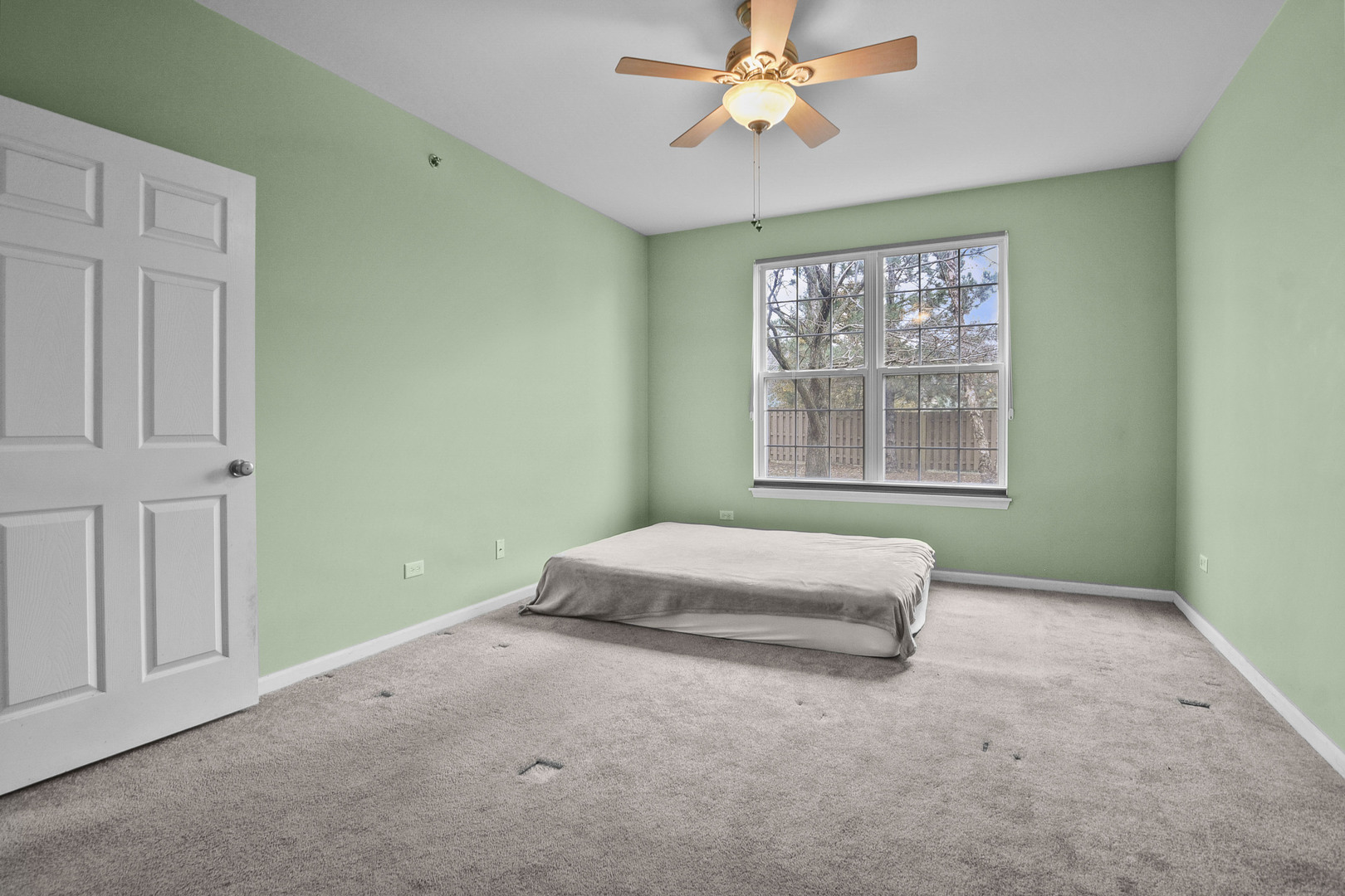 8815 Concord Lane, Unit G Justice, IL 60458 - Photo 17 of 27 a spacious bedroom with a bed and a window