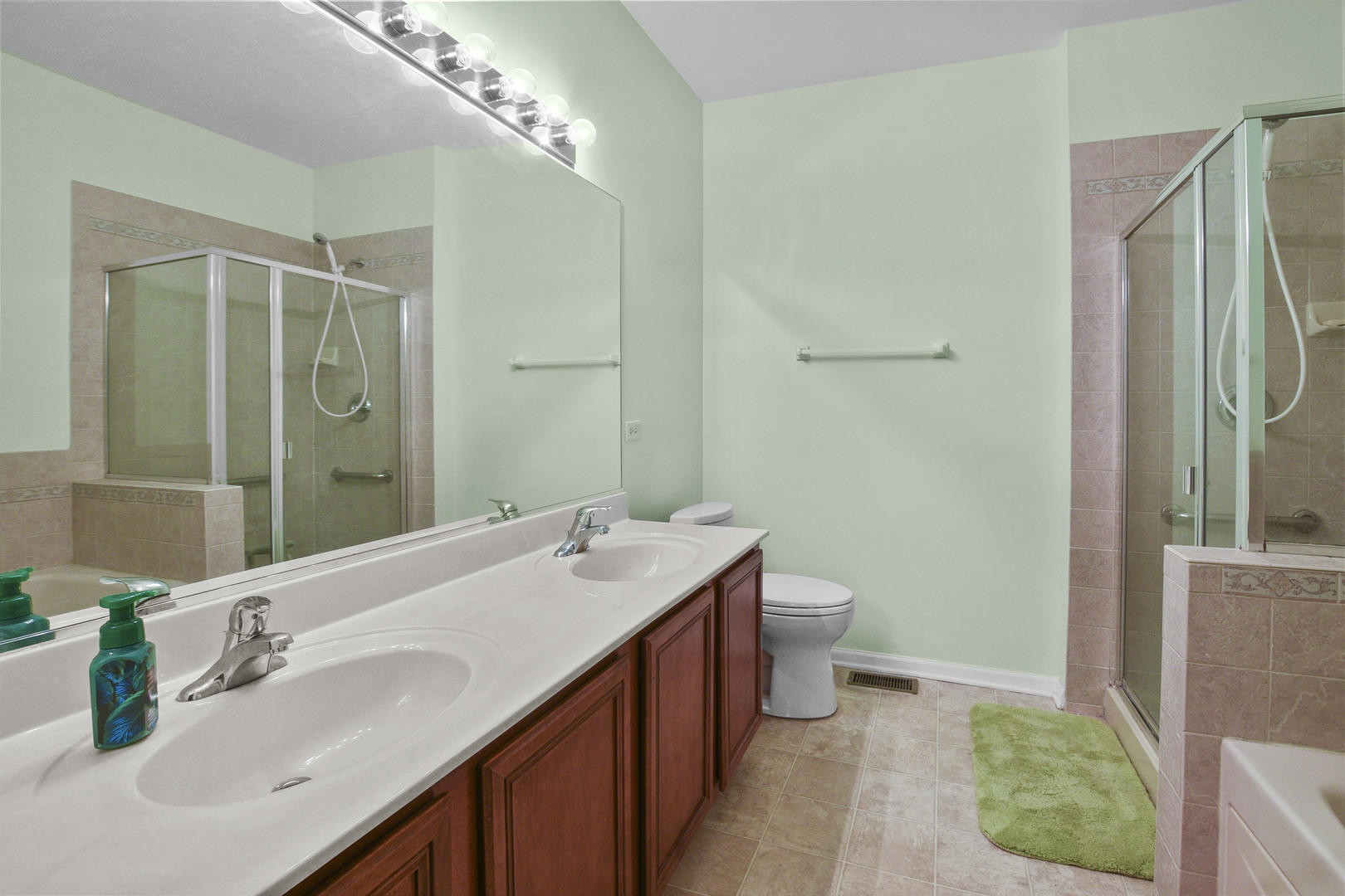 8815 Concord Lane, Unit G Justice, IL 60458 - Photo 19 of 27 a bathroom with a double vanity sink mirror and toilet