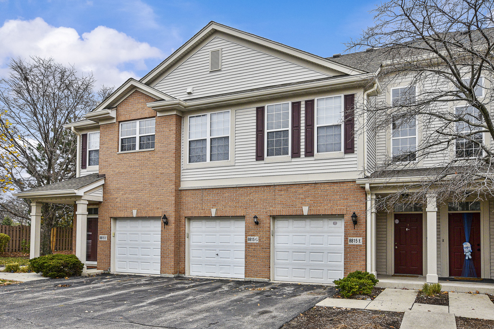 8815 Concord Lane, Unit G Justice, IL 60458 - Photo 2 of 27 a front view of a house with a yard and garage
