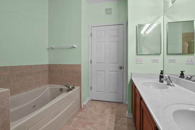 a bathroom with a bathtub sink and mirror