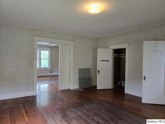 242 Main Street Carthage, IL 62321 - Photo 11 of 28 an empty room with wooden floor and closet