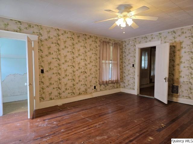 242 Main Street Carthage, IL 62321 - Photo 23 of 28 wooden floor in an empty room with a window