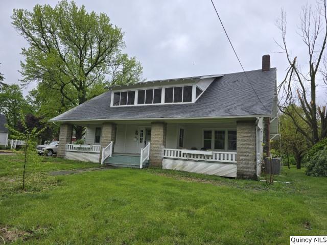 242 Main Street Carthage, IL 62321 - Photo 26 of 28 a front view of a house with a garden