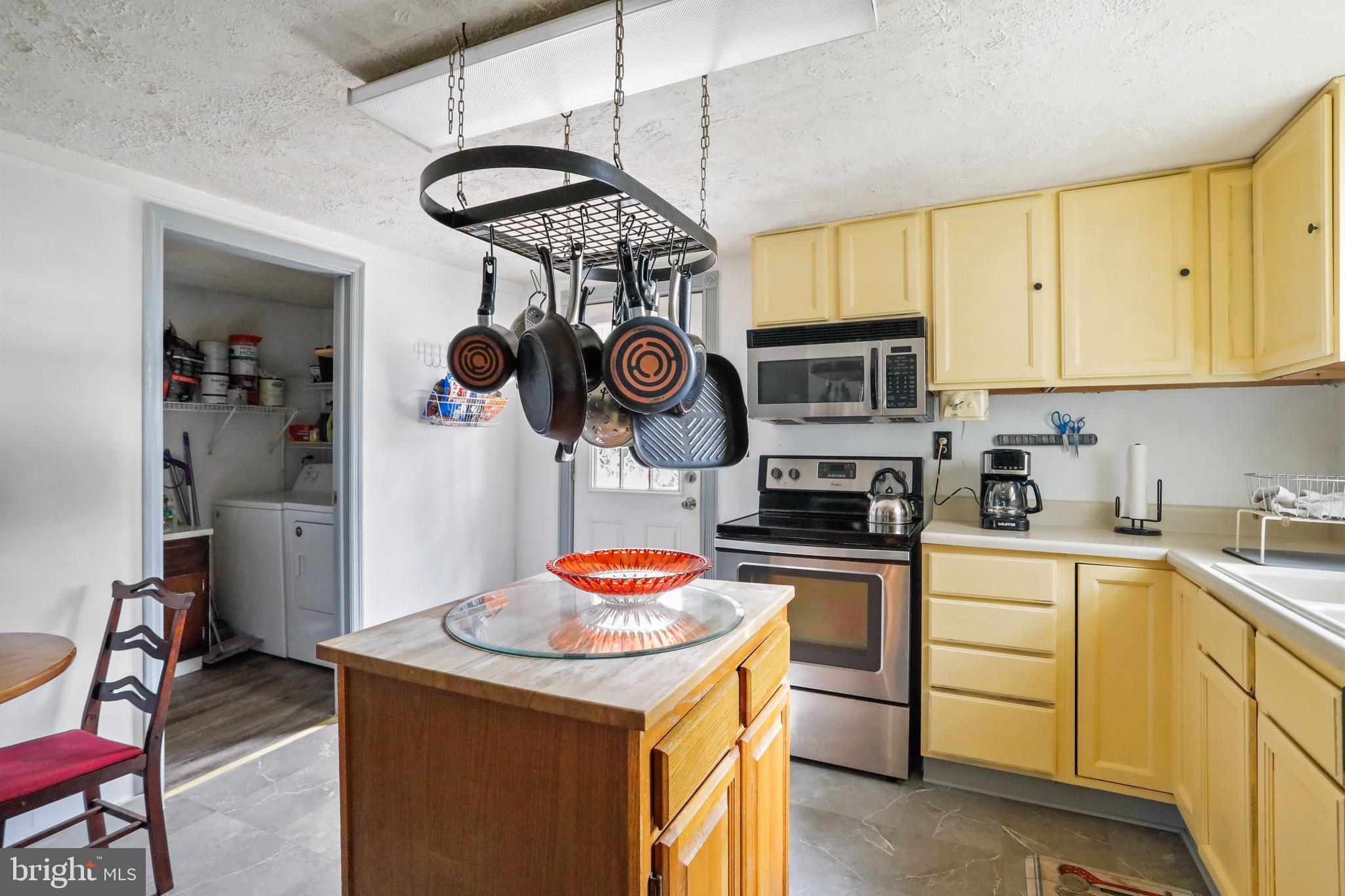 13618 Coppermine Road Union Bridge, MD 21791 - Photo 9 of 29 a kitchen with stainless steel appliances granite countertop a sink a stove and cabinets