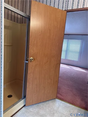 a view of an empty room with a bathroom