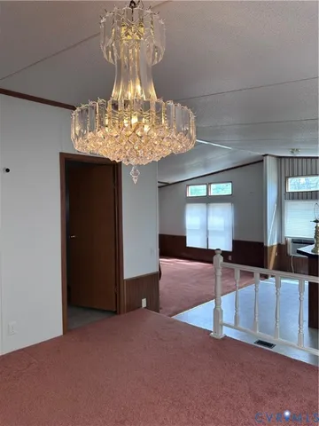 a lobby with furniture and chandelier