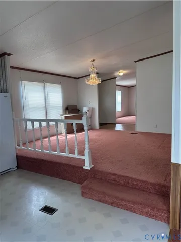 a living room with furniture and a ceiling fan