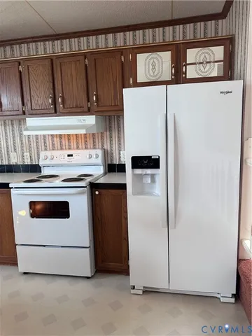 a white refrigerator freezer sitting inside of a kitchen