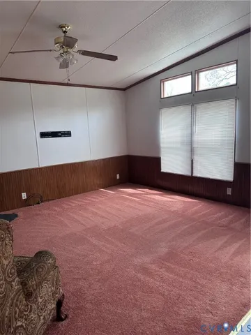 a view of a room with window and ceiling fan