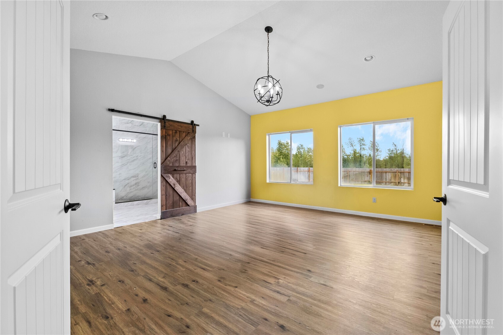 249 Flatt Road Kelso, WA 98626 - Photo 16 of 39 a view of an empty room with a window and wooden floor
