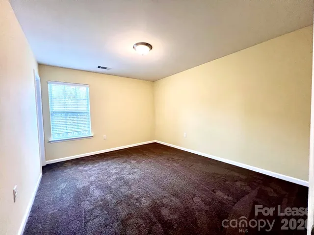 an empty room with a empty space and a window