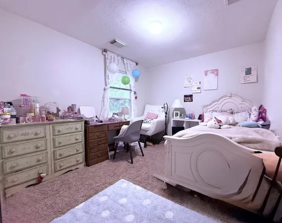 a bed room with a bed and a window