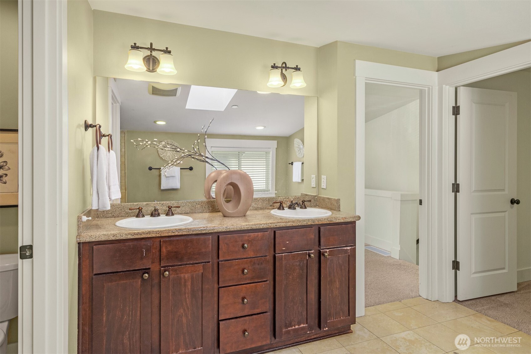 5233 Russell Avenue Northwest, Unit A Seattle, WA 98107 - Photo 21 of 29 a en suite bathroom with a granite countertop sink and a mirror