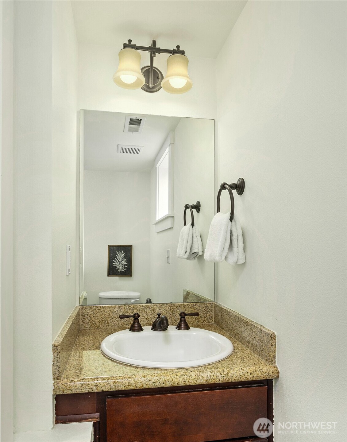 5233 Russell Avenue Northwest, Unit A Seattle, WA 98107 - Photo 25 of 29 a bathroom with a sink and a mirror